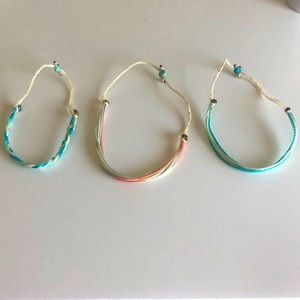 Three adjustable bracelets.